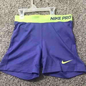 Purple Nike Pros 5” with a lime green band.